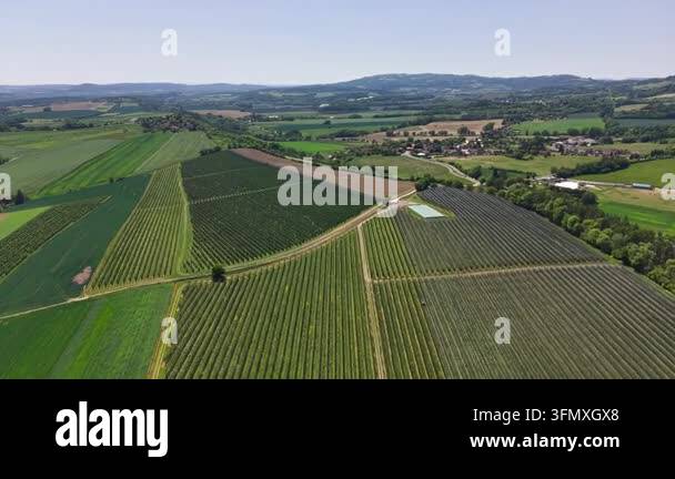 a beautiful aerial shot of a rural landscape with a farm field and a ...