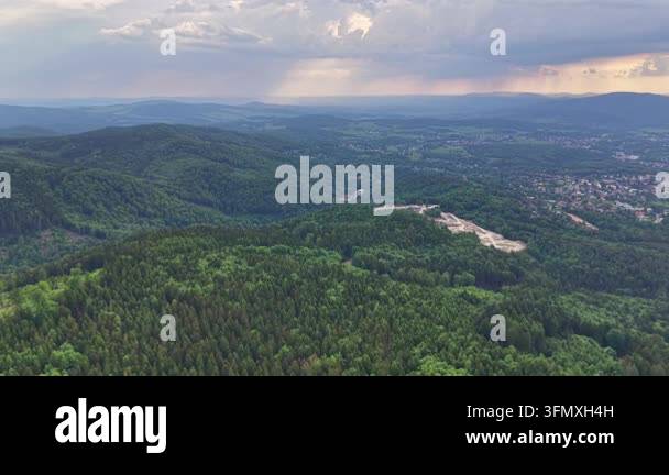 aerial view of green hills with mountains and forest. summer evening ...