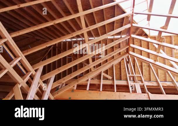 Workers are building roof structure using wooden beams for construction ...