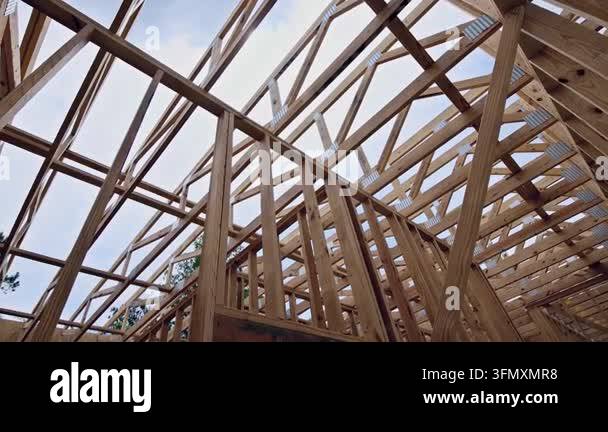 Construction workers are building wooden beams trusses structure of ...