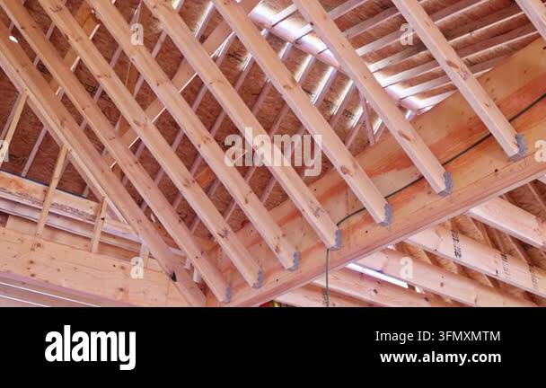 Wooden beams are arranged in roof framing beams structure of building ...