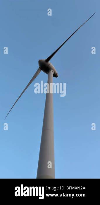 a vertical shot of wind turbine against the blue sky Stock Video ...