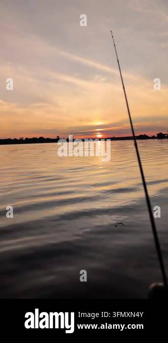 a fishing boat at sunset Stock Video Footage - Alamy