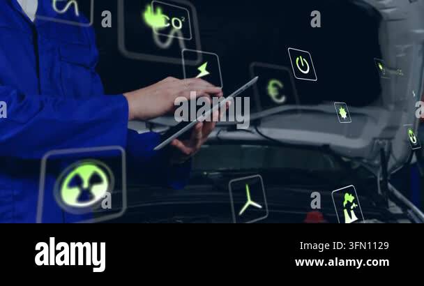 Technician tapping tablet in garage activating CO energy icons to ...