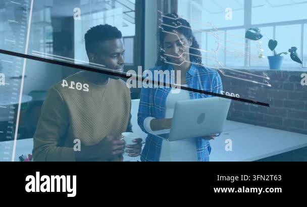 Coworkers reviewing laptop screen, floating code overlays illustrating ...