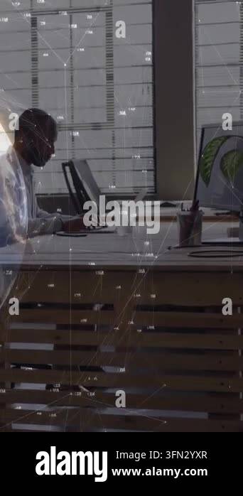 Analyst typing in tech office activating graph overlay smiling at ...