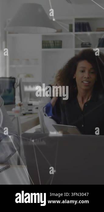 Vertical video: Woman leaning into laptop after colleague pointing ...