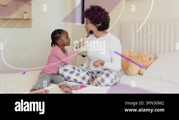 Child picking up brush, applying blush to woman on bed, purple overlays ...