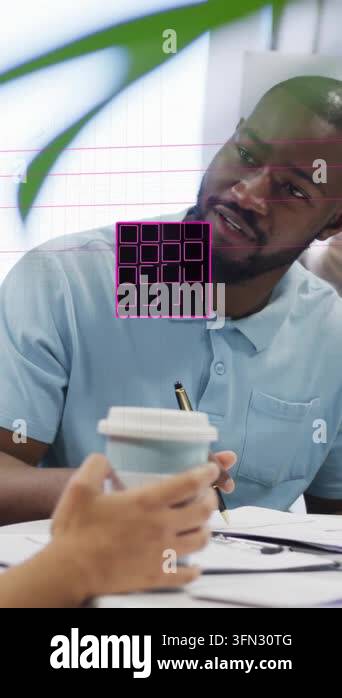 Vertical video: Worker writing notes in office, hand lifting cup ...