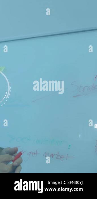 Vertical video: Host writing target market on board with red marker ...