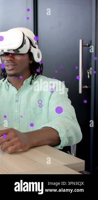 Vertical video: Man with VR headset gesturing on desk, testing ...