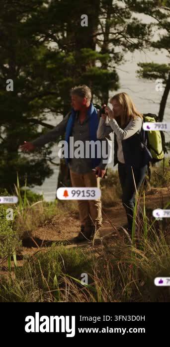 Vertical video: Pair walking trail, woman using cam causing floating UI ...