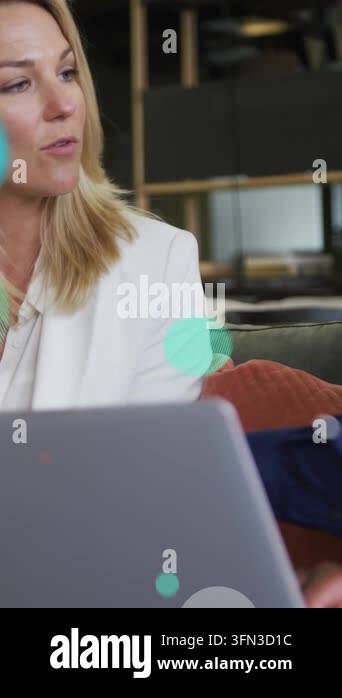 Vertical video: Business pro checking laptop after peer prompt while ...