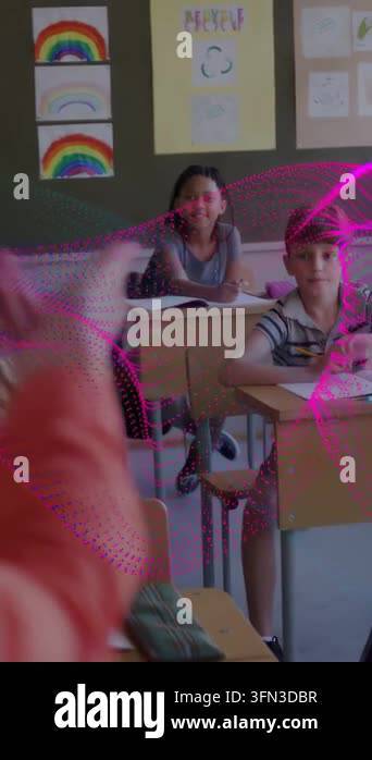 Vertical video: Boy writing, raising hand after cue, girl watching as ...