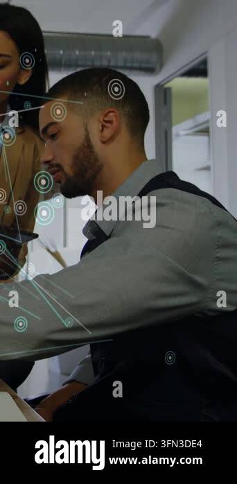 Vertical video: Woman leaning in showing tablet causing node links man ...