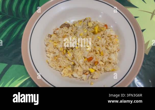 Footage of homemade fried rice served on a plate, representing a simple ...