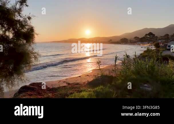 Aerial view of Roda beach in North Corfu Greece at sunrise with golden ...