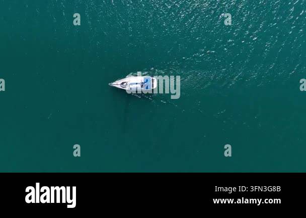 Top Down Aerial View of a Yacht Sailing in Clear Turquoise Sea Water in ...