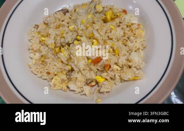 Footage of homemade fried rice served on a plate, representing a simple ...
