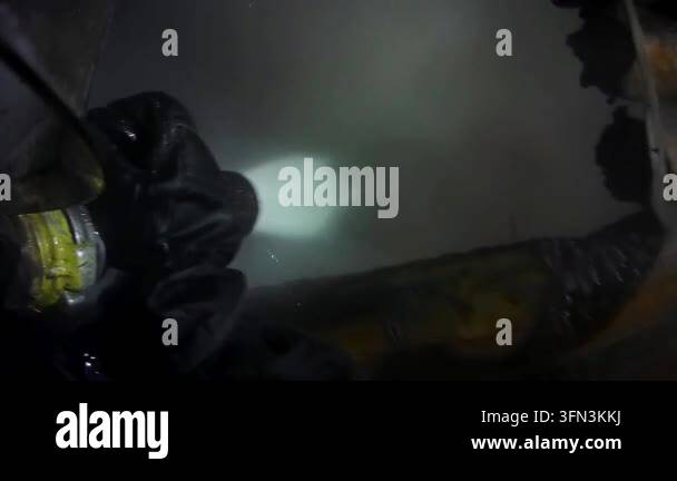 Firefighter rescuer explores smoke-filled scene, illuminating ...