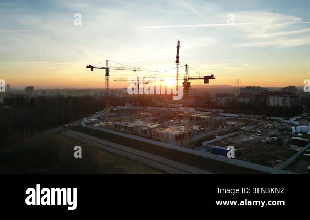 Aerial view of modern residential complex construction with cranes at ...