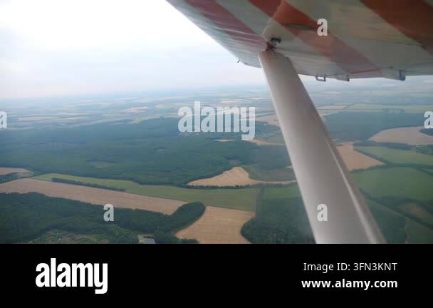 Aerial view from a plane wing showcasing expansive green fields and ...