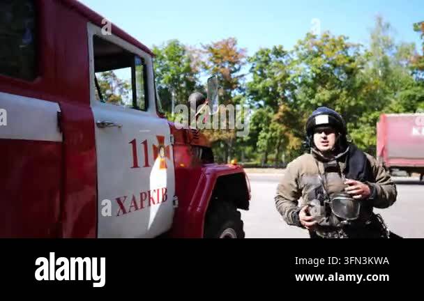 Professional firefighter taking oxygen tank from big truck and running ...