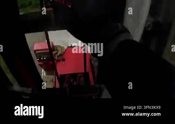 Firefighter rescuer climbs ladder towards smoke-filled building ...