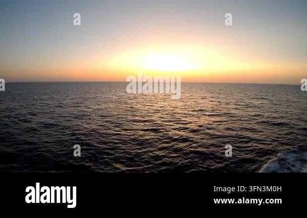Serene ocean sunset sequence showcasing the gradual transition of ...