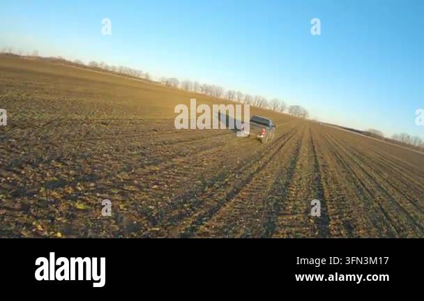 Off Signe Car moving among farmland on daytime. Flying over pickup truck driving ...