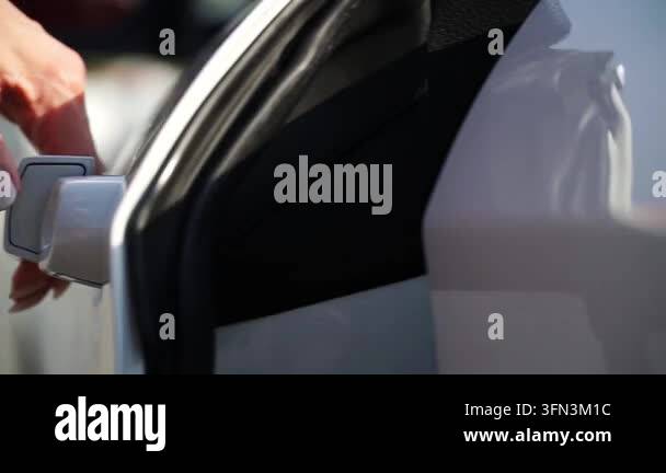 Hand approaches car door handle, followed by a glimpse into the ...
