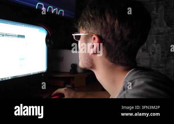 Young male trader is deeply engaged in cryptocurrency analysis ...