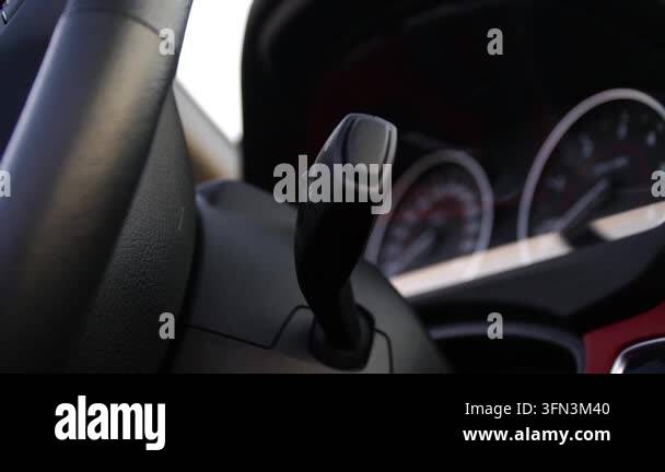 Close-up of car gear shift lever in motion, capturing the smooth ...