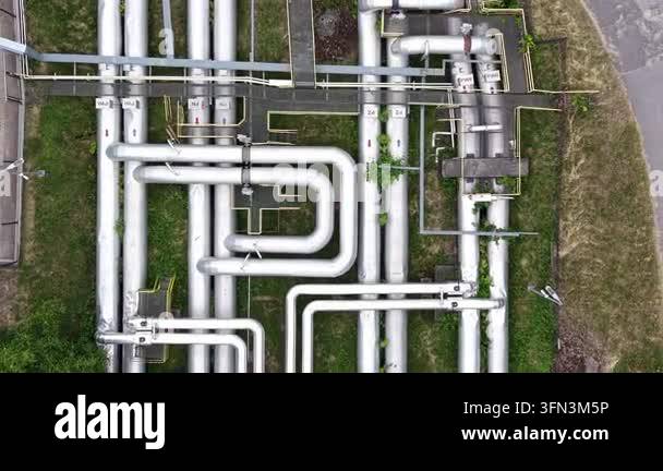 Aerial view of interconnected industrial pipelines with green ...