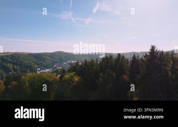 Aerial view of a small village nestled in a valley surrounded by lush ...