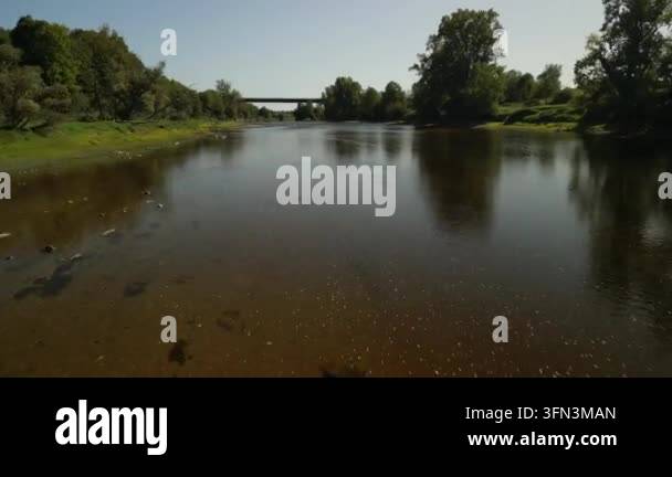 Aerial view of a wide river flowing through a lush green landscape with ...