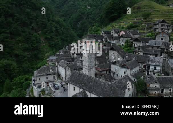 Aerial view of a historic village nestled in a lush green valley with ...