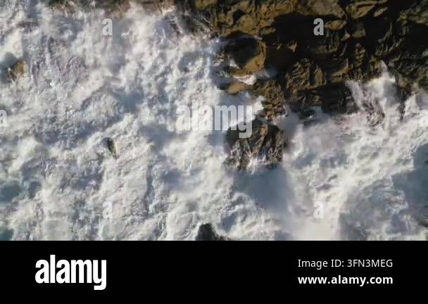 sea waves crashing against rocky shore Stock Video Footage - Alamy