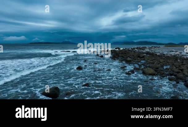 Calm ocean waves crashing against rocks Stock Video Footage - Alamy