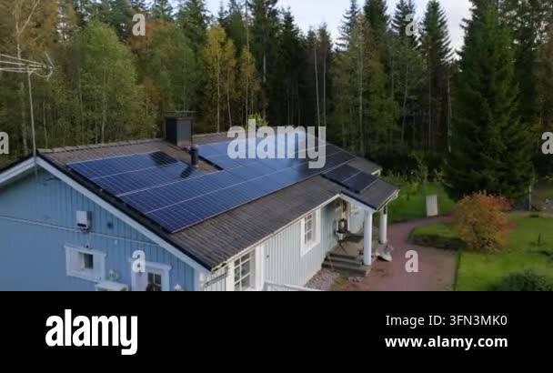 Aerial view of a light blue house with solar panels installed on the ...
