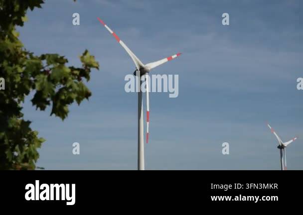 Wind turbines rotating against blue sky Stock Video Footage - Alamy