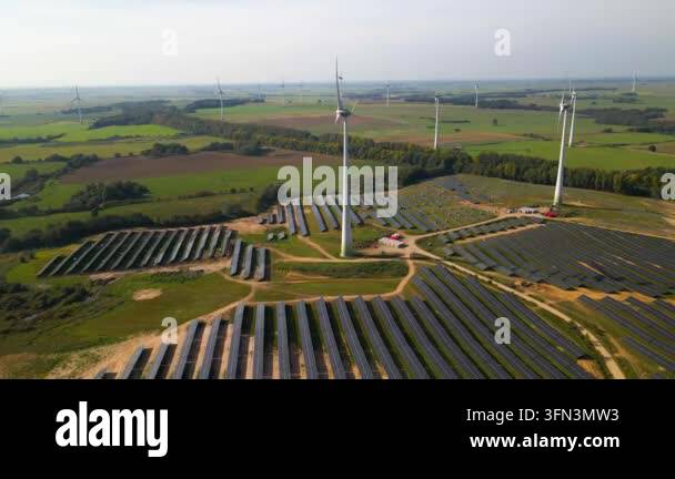 Aerial view of solar panels and wind turbines in field Stock Video ...