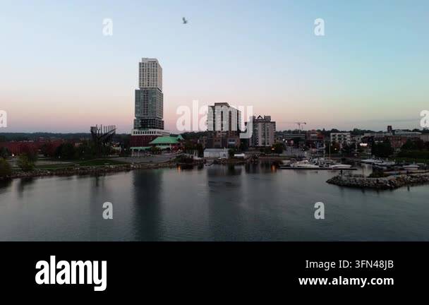 Modern tall buildings and a city skyline along a calm riverfront Stock ...