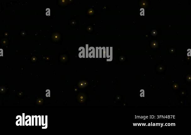 Abstract background of glowing golden particles floating and twinkling ...