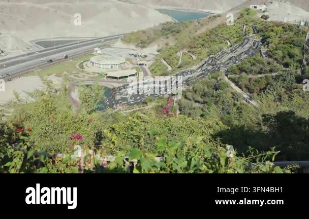 Aerial view of winding road through green hills Stock Video Footage - Alamy