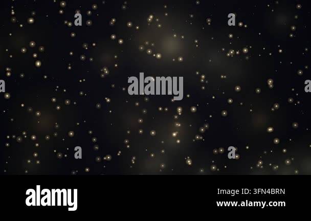 Abstract background of glowing golden particles floating and twinkling ...