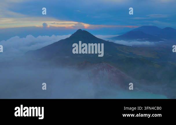 Volcantic Rocks Volcanic Mountain Peak at Sunrise Surrounded by Clouds Stock Video ...