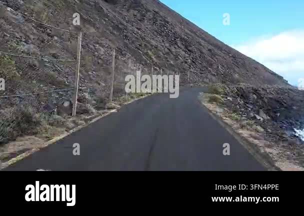 Volcantic Rocks Driving a coastal road in a volcanic landscape, Island El Hierro, Spain ...