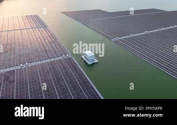 Floating solar panels stretch across calm, green water Stock Video ...