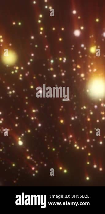 Glowing golden particles and radiant orange light beams form a warm ...